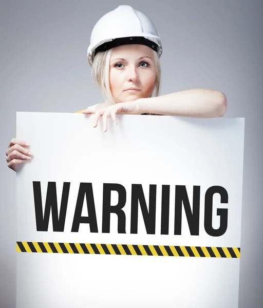 Caution sign held by worker — Stock Photo, Image