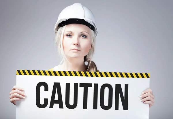 Caution sign held by worker — Stock Photo, Image