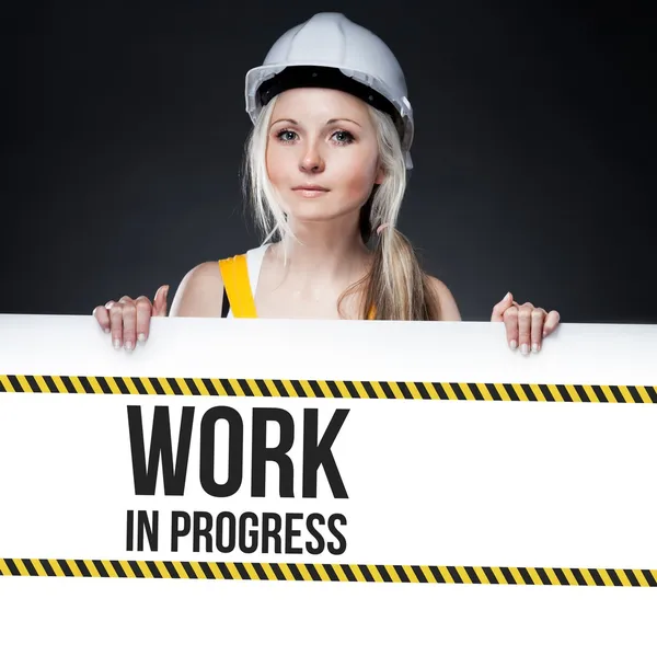 Work in progress Zeichen auf der Tafel, Arbeiterin — Stockfoto