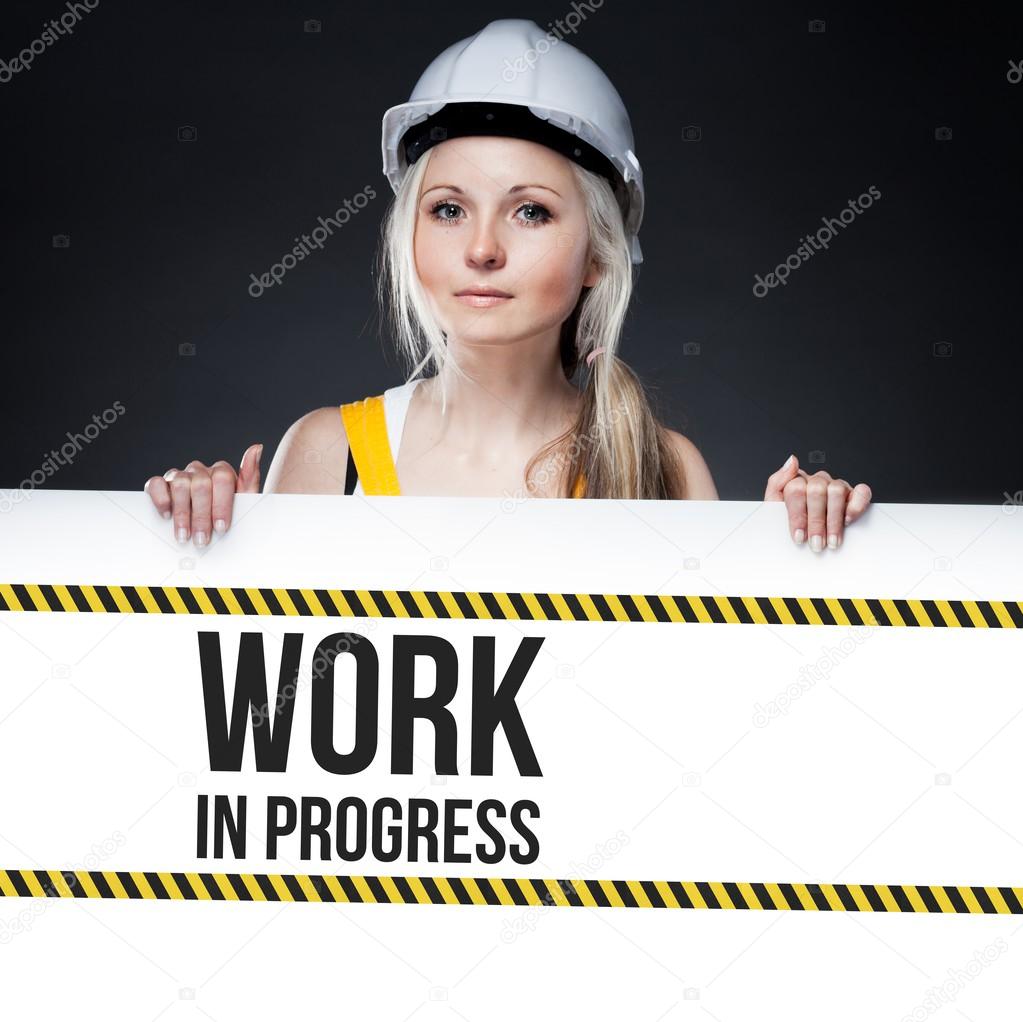 Work in progress sign on template board, worker woman