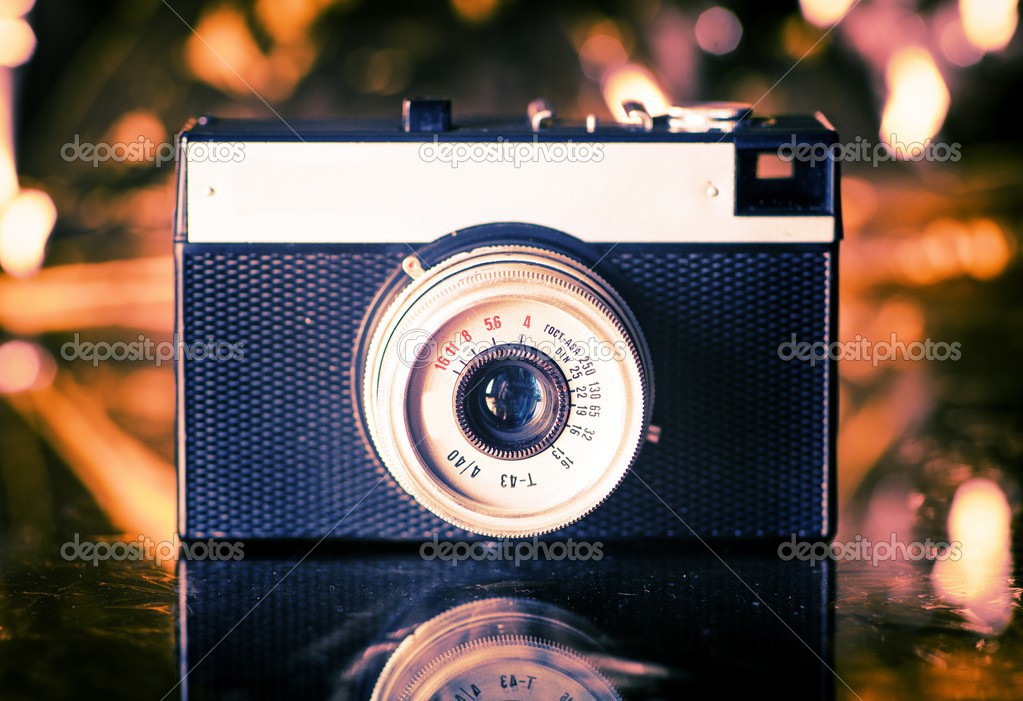 Old camera on gold background