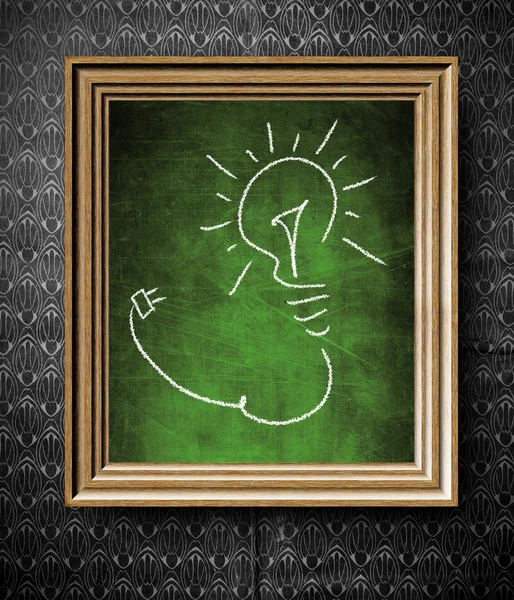 Idea concept light bulb chalkboard in old wooden frame — Stock Photo, Image