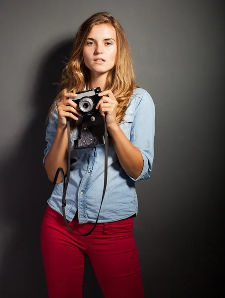 Sexy photographer in jeans shirt with old camera — Stock Photo, Image
