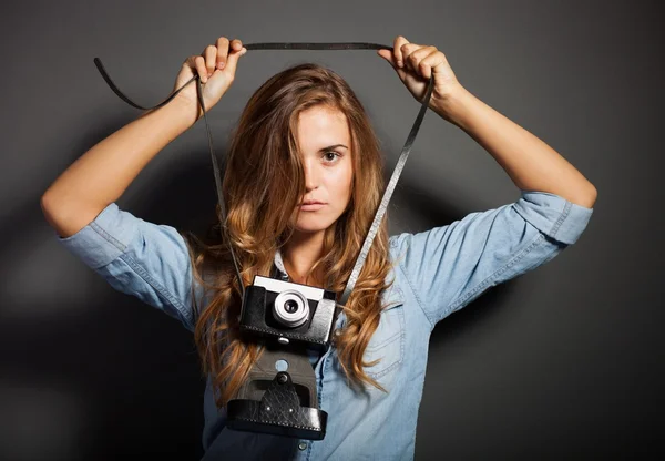 Sexy photographer in jeans shirt with old camera — Stock Photo, Image