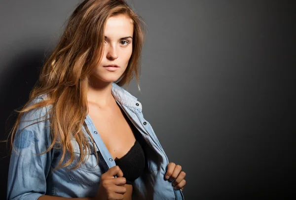 Sexy woman in long sleeve white t-shirt, dark background — Stock Photo, Image