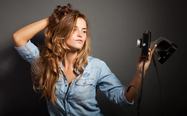 Sexy woman taking pictures with old camera — Stock Photo, Image