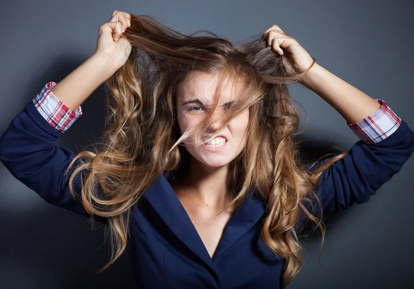 Shouting angry girl pulling hair — Stock Photo, Image