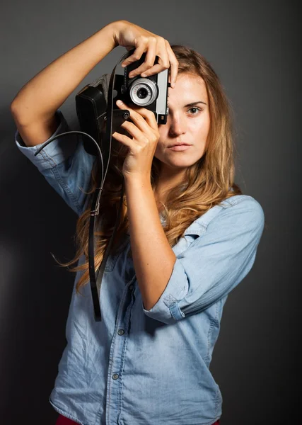 Young photographer in jeans jacket with old camera — Stock Photo, Image