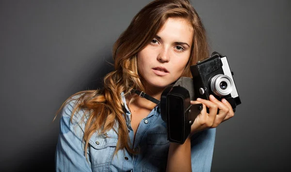 Thinking photographer woman with old camera — Stock Photo, Image