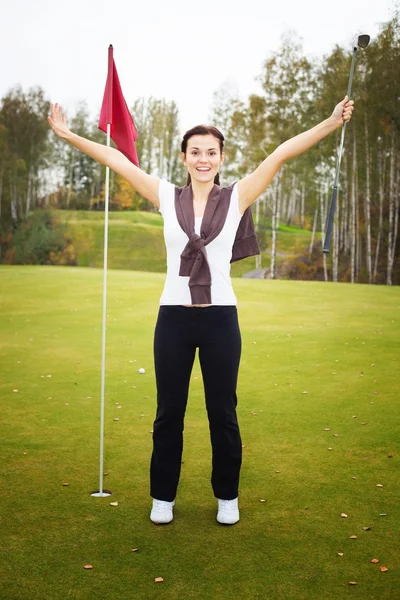 Feliz y sonriente jugadora de golf en pose ganadora —  Fotos de Stock