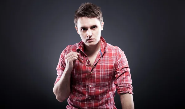 Portrait of casual young thoughtful man in red shirt — Stock Photo, Image