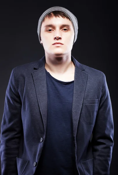 Portrait of casual young man wearing jacket and cap — Stock Photo, Image