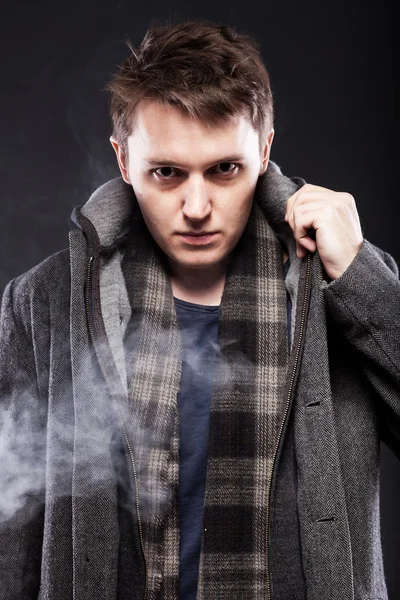 Handsome young man in smoke — Stock Photo, Image