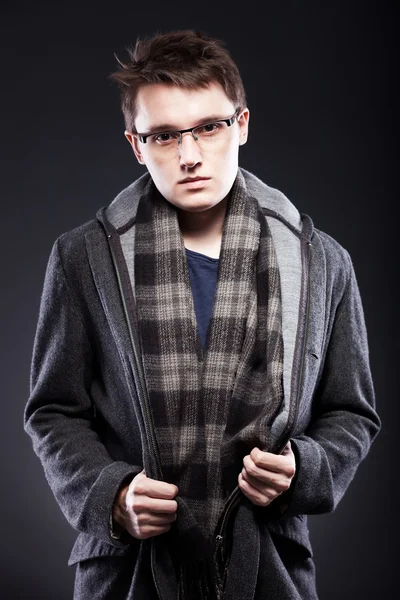 Elegant young man in coat and glasses — Stock Photo, Image