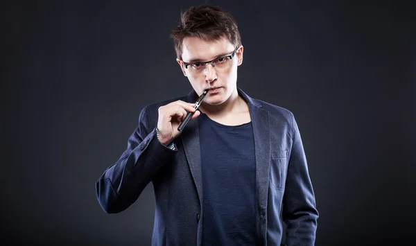 Young man smoking electronic cigarette — Stock Photo, Image