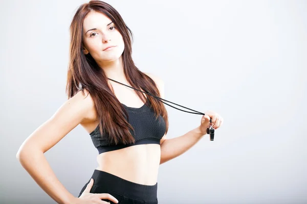 Beautiful fitness trainer in sports bra and whistle — Stock Photo, Image