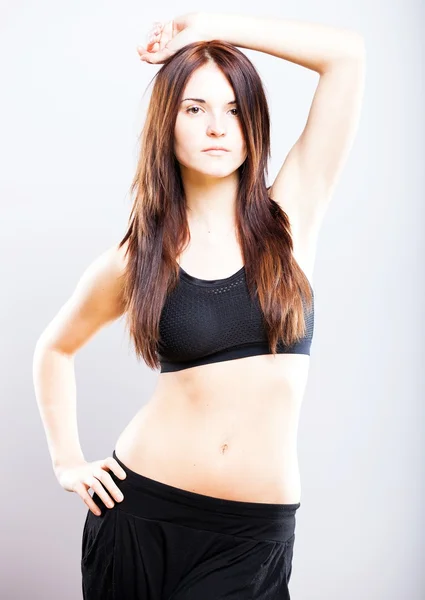 Young athletic woman posing in sports bra — Stock Photo, Image