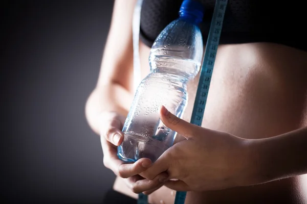 Woman after training holding water bottle — Stock Photo, Image