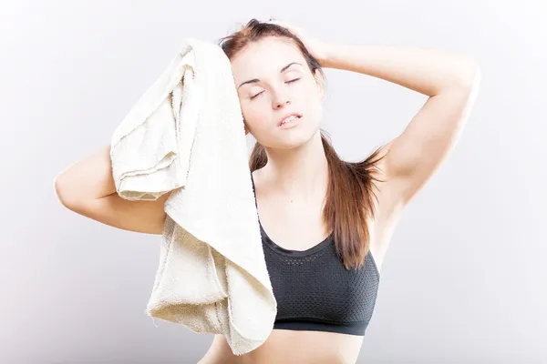 Tired woman after fitness exercise with towel — Stock Photo, Image