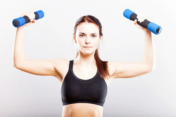 Young fit woman training with dumbbells — Stock Photo, Image