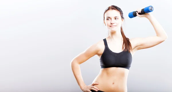 Young fit woman training with dumbbells — Stock Photo, Image