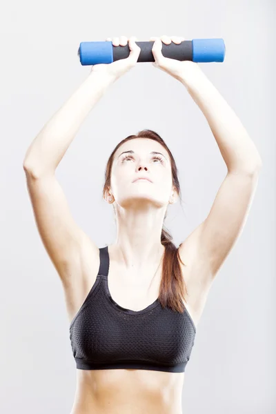 Fit woman during exercise with dumbbells — Stock Photo, Image