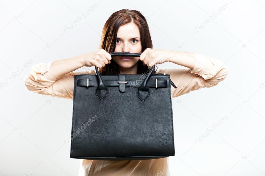 Elegant young woman with leather bag
