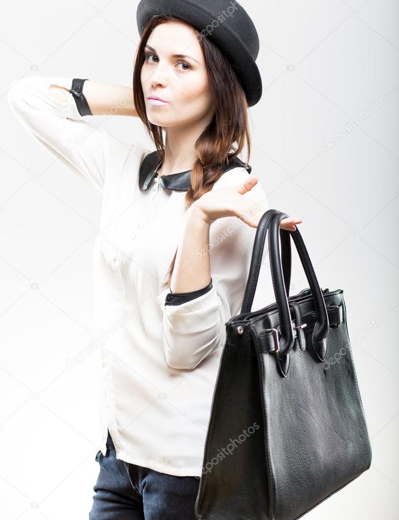 Portrait of stylish young woman with leather bag