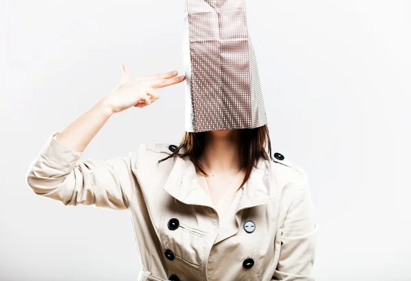 Consumerism fashionable woman with shopping bag on head — Stock Photo, Image