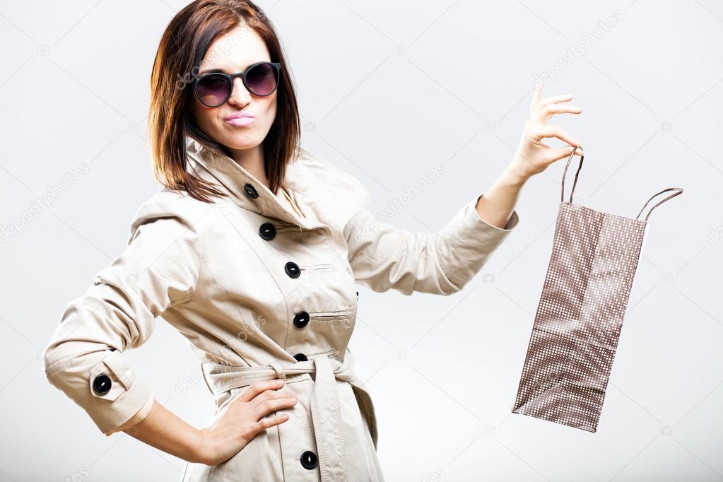 Disappointed becouse of shooping, woman holding bag