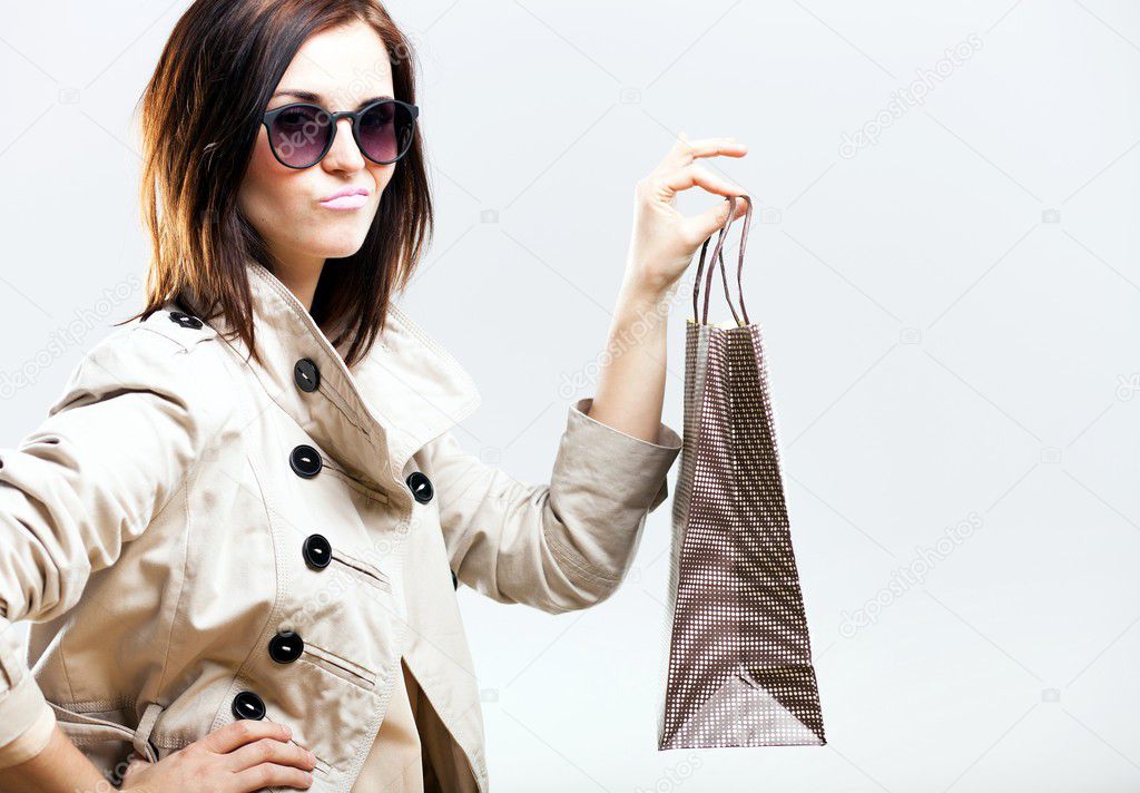 Unhappy woman holding shopping bag