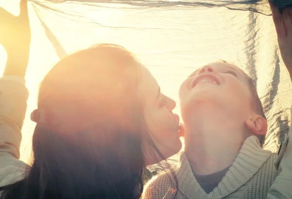 Mother kissing her child druing playing — Stock Photo, Image