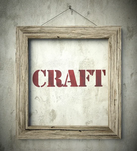 Craft in old wooden frame on wall — Stock Photo, Image