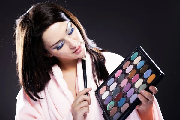 Woman in bathrobe, make up palette — Stock Photo, Image