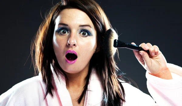 Funny surprised woman in bathrobe and powder brush — Stock Photo, Image