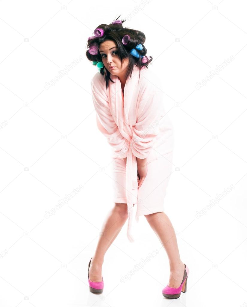 Embarrassed woman in bathrobe, isolated white