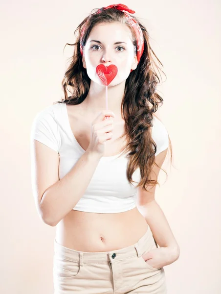 Pin up girl and lollipop in shape of heart — Stock Photo, Image