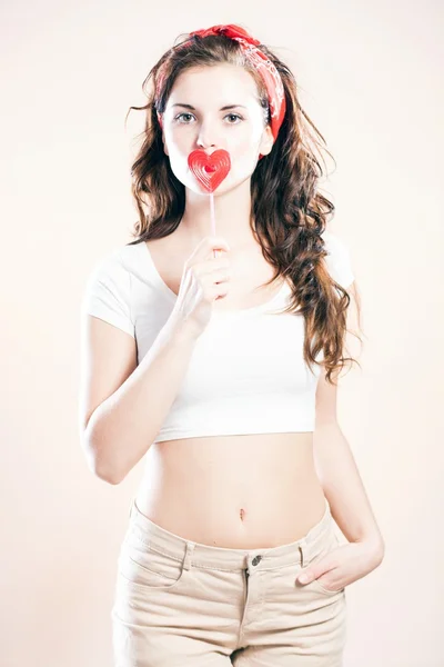 Pin up girl, valentine lollipop in shape of heart — Stock Photo, Image