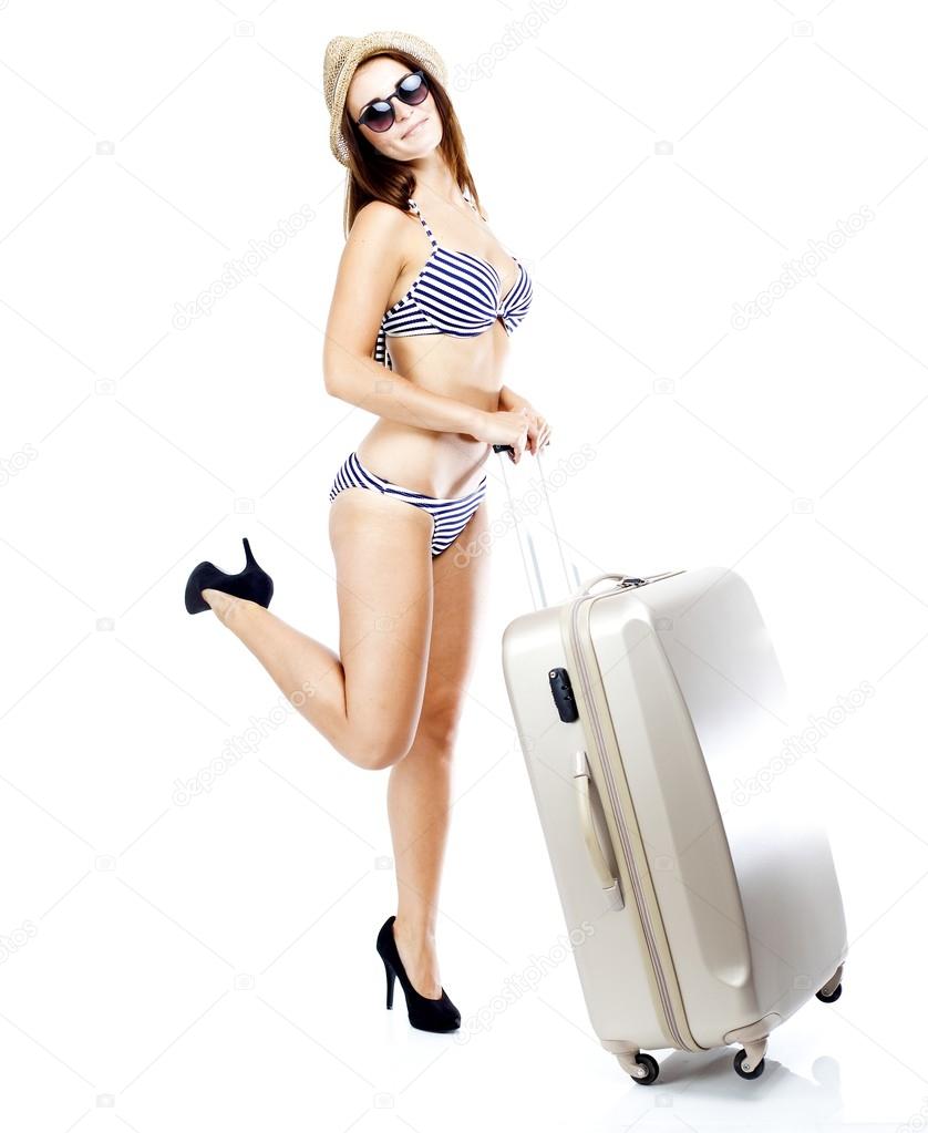 Tourist woman in bikini with suitcase isolated