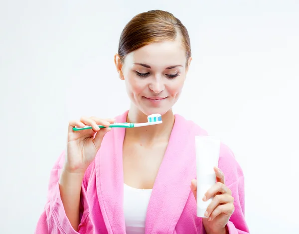 Woman with toothbrush and tooth paste tube — Stock Photo, Image