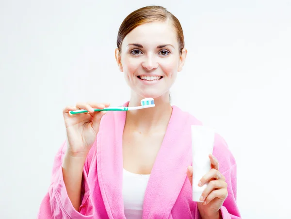 Woman with toothbrush and tooth paste tube — Stock Photo, Image