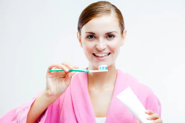 Woman with toothbrush and tooth paste tube — Stock Photo, Image