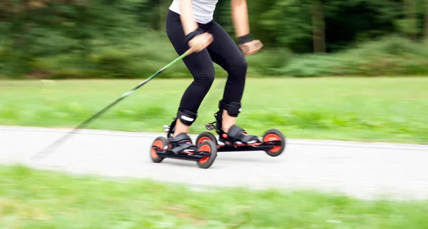 Woman cross-country skiing with roller ski — Stock Photo, Image
