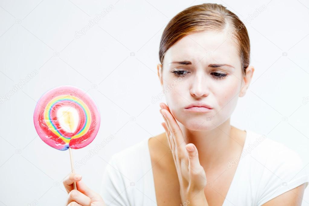 Woman having toothache after eating sweets — Stock Photo © leszekglasner 51643587