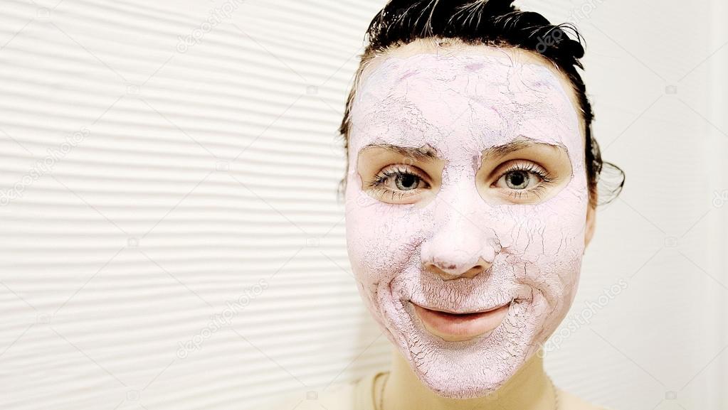 Portrait of a woman with spa mask on a white background