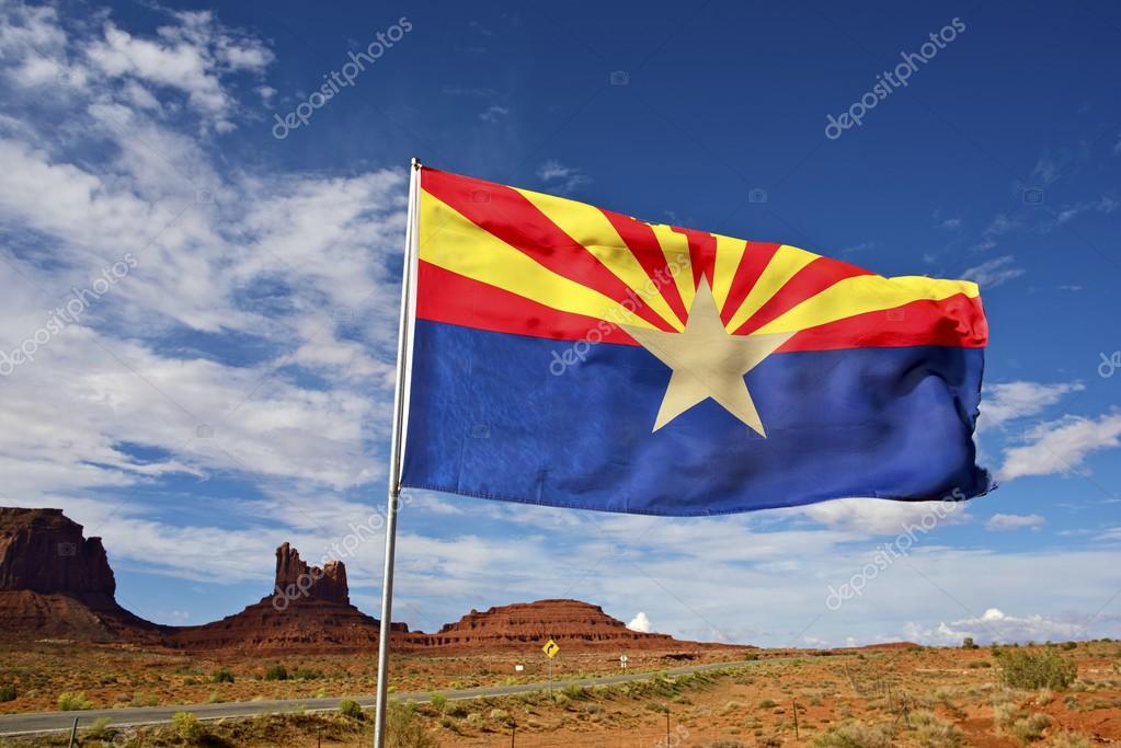 Arizona Flag on Wind. Arizona State Desert Landscape Near Monuments Valley, AZ, United States.