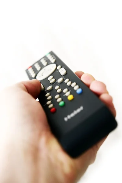 Control remoto de tv en la mano —  Fotos de Stock
