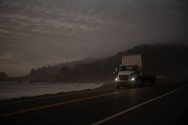 Semi Truck on the California 101 Coastal Highway Right After Sunset. Scenic Pacific Shore Highway.