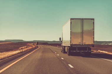 Semi Trailer Truck on an American West Route. Interstate I-70 Utah, United States of America. Rear View. 