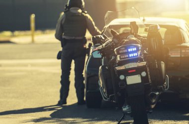 Motorcycle Police Officer Giving Traffic Ticket to Speeding Driver. Driving Theme.